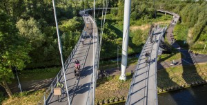 A brigde with people driving on their bicycles. 