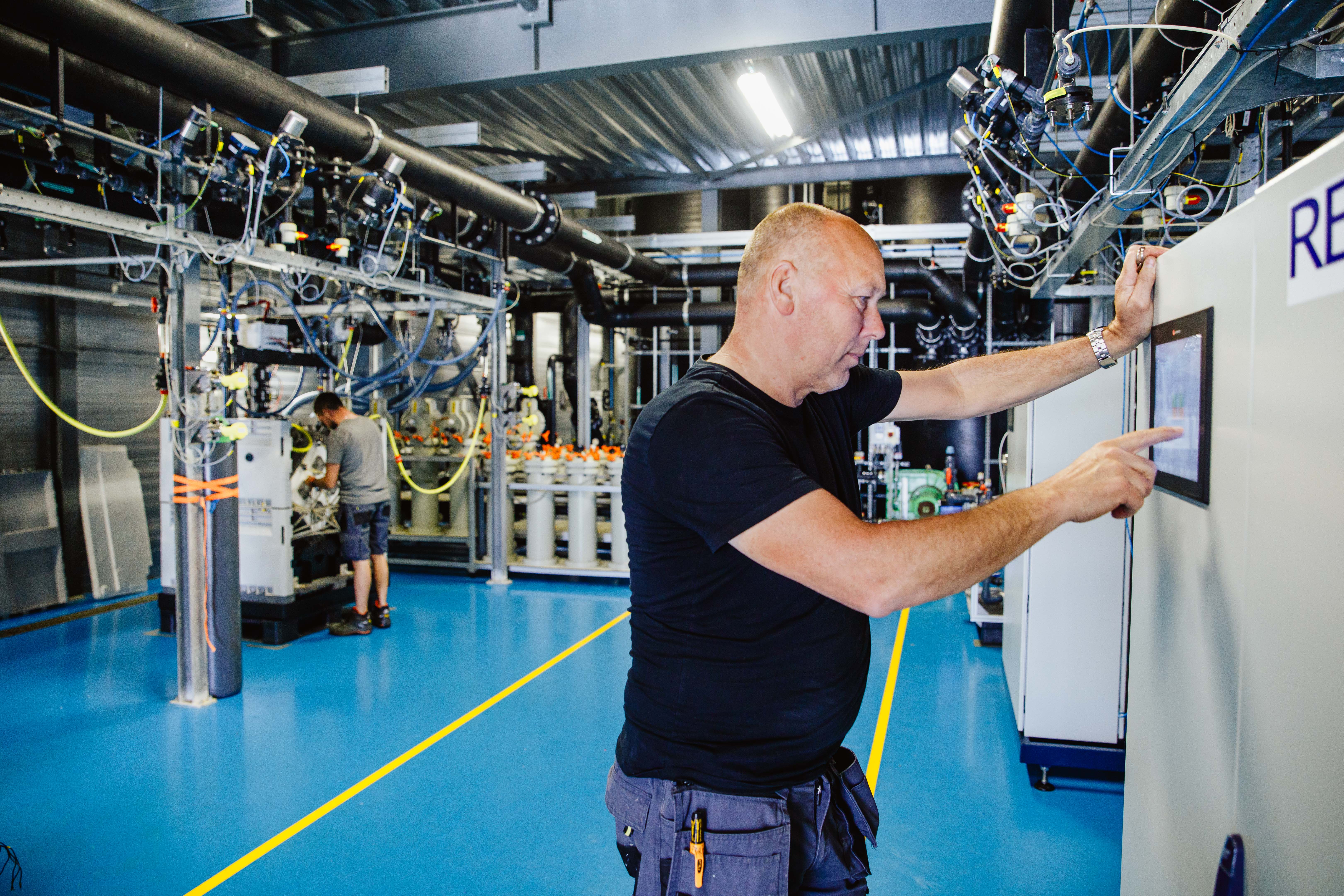 REDstack employee checks a laboratory research solution.